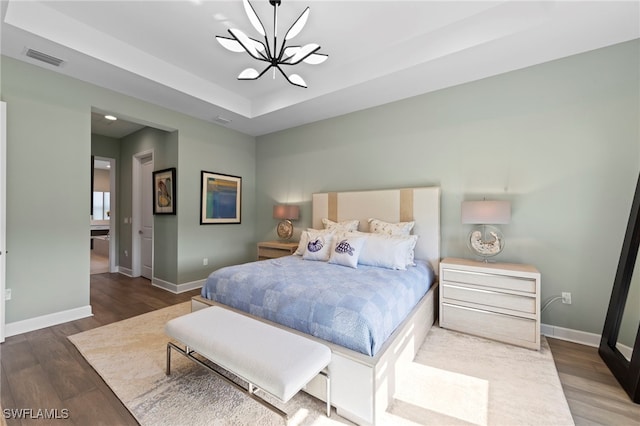 20368 Estero Crossing Blvd, Estero, FL 33928 - bedroom featuring a chandelier, wood finished floors, and a raised ceiling