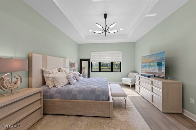 20368 Estero Crossing Blvd, Estero, FL 33928 - bedroom with a chandelier, a tray ceiling, recessed lighting, and wood finished floors