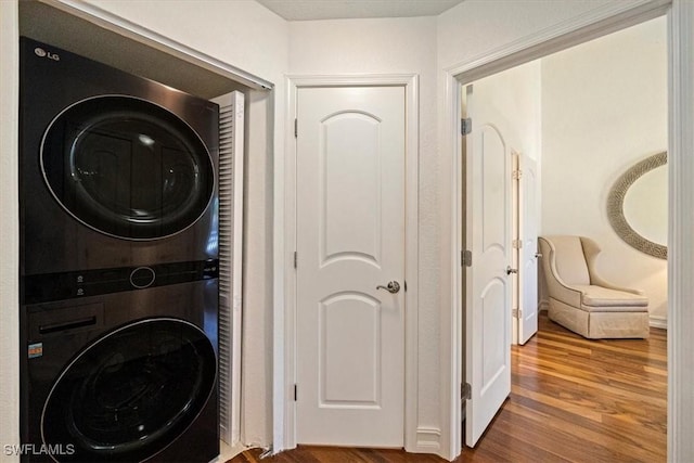 60 Emerald Woods Dr Unit B11, Naples, FL 34108 - laundry room featuring stacked washer / drying machine and wood finished floors