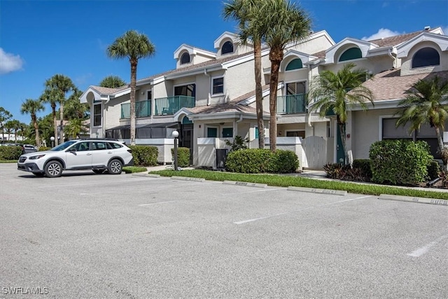 60 Emerald Woods Dr Unit B11, Naples, FL 34108 - view of building exterior featuring uncovered parking