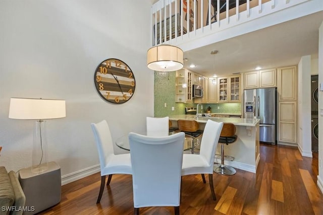 60 Emerald Woods Dr Unit B11, Naples, FL 34108 - dining area featuring dark wood-type flooring and a high ceiling