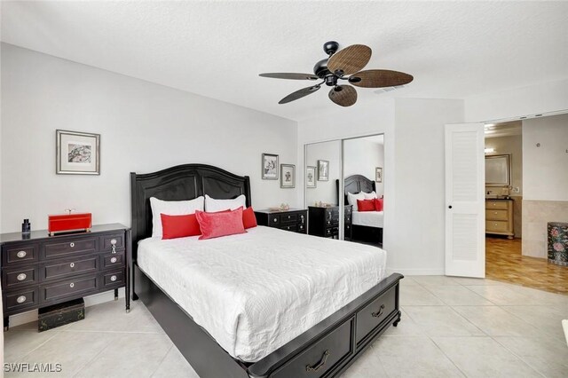 3128 Andorra Ct, Naples, FL 34109 - bedroom featuring light tile patterned floors, a closet, a ceiling fan, and a textured ceiling