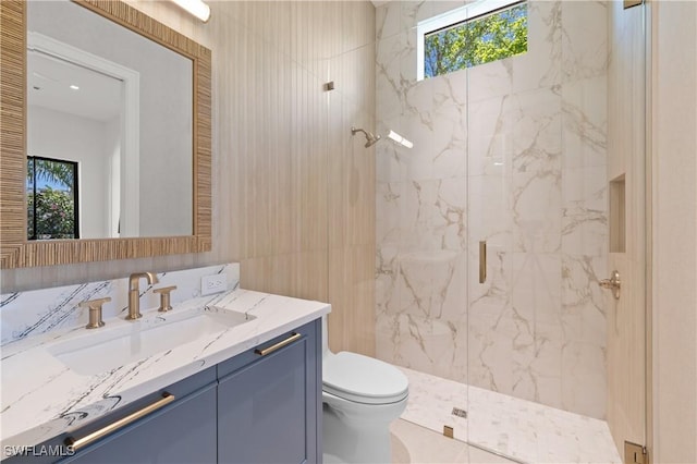 850 10th St N, Naples, FL 34102 - full bath with a marble finish shower, vanity, and healthy amount of natural light