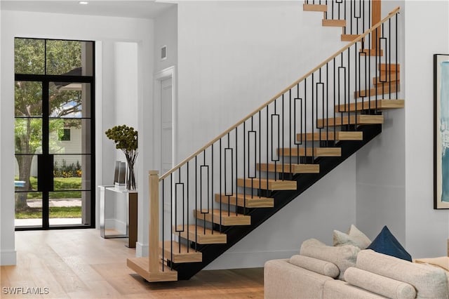 850 10th St N, Naples, FL 34102 - staircase with wood finished floors, healthy amount of natural light, and a high ceiling