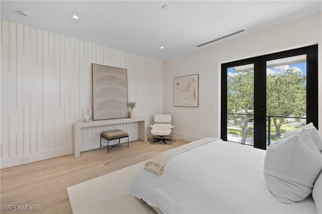 850 10th St N, Naples, FL 34102 - bedroom featuring wood finished floors, french doors, recessed lighting, access to exterior, and radiator heating unit