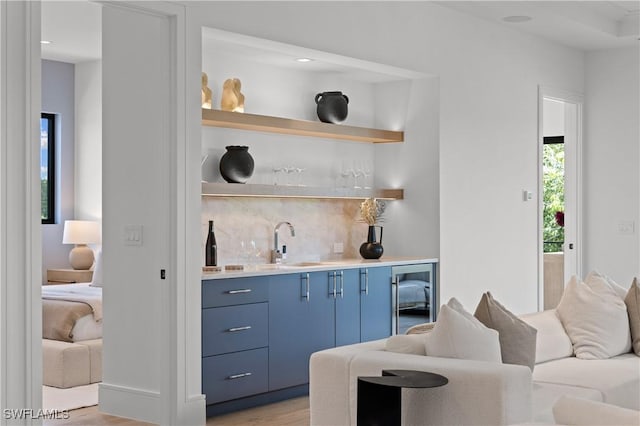 850 10th St N, Naples, FL 34102 - indoor wet bar featuring beverage cooler, backsplash, light wood-style floors, and recessed lighting