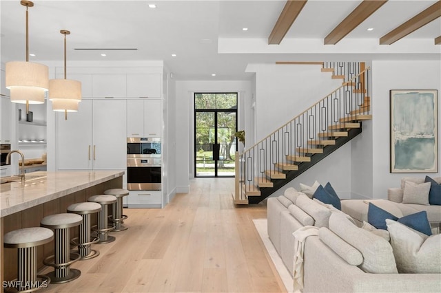 850 10th St N, Naples, FL 34102 - living area featuring stairs, light wood-style flooring, recessed lighting, and beam ceiling
