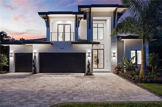 850 10th St N, Naples, FL 34102 - contemporary home with a balcony, stucco siding, decorative driveway, and french doors