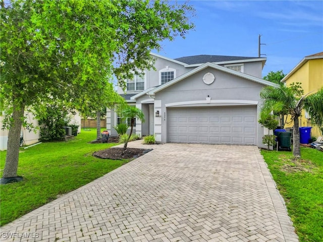 8094 Silver Birch Way, Lehigh Acres, FL 33971 - traditional home with decorative driveway, stucco siding, a garage, and a front yard
