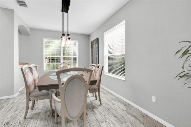 8094 Silver Birch Way, Lehigh Acres, FL 33971 - dining space featuring wood finish floors and a chandelier