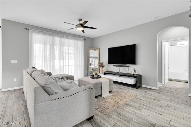 8094 Silver Birch Way, Lehigh Acres, FL 33971 - living area featuring arched walkways, ceiling fan, and light wood finished floors