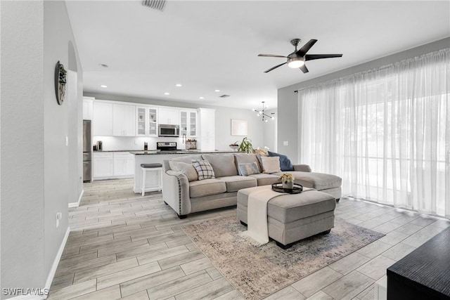 8094 Silver Birch Way, Lehigh Acres, FL 33971 - living area with a ceiling fan, wood finish floors, recessed lighting, and a chandelier