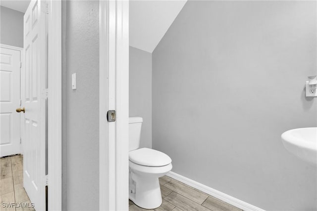8094 Silver Birch Way, Lehigh Acres, FL 33971 - bathroom with vaulted ceiling and wood finished floors