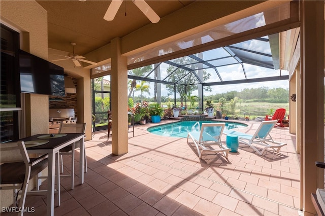 3681 Mossy Oak Dr, Fort Myers, FL 33905 - swimming pool featuring a ceiling fan, exterior kitchen, a patio area, and glass enclosure