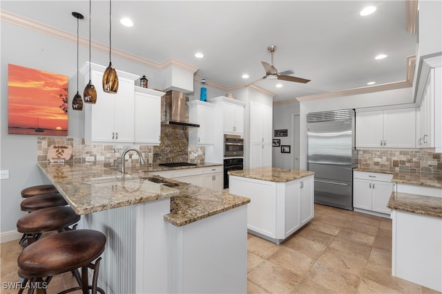 3681 Mossy Oak Dr, Fort Myers, FL 33905 - kitchen featuring stainless steel appliances, a peninsula, wall chimney exhaust hood, ornamental molding, and decorative backsplash