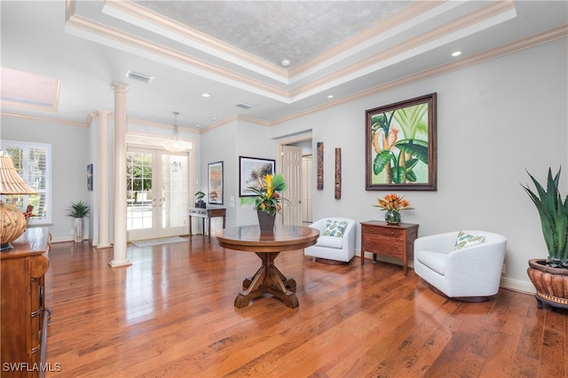 3681 Mossy Oak Dr, Fort Myers, FL 33905 - sitting room featuring a raised ceiling, decorative columns, crown molding, and wood finished floors