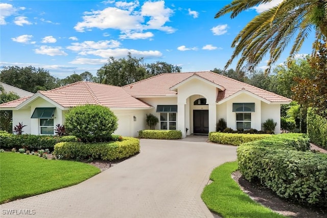 6632 Glen Arbor Way, Naples, FL 34119 - view of front of home with a garage, stucco siding, a tiled roof, and driveway