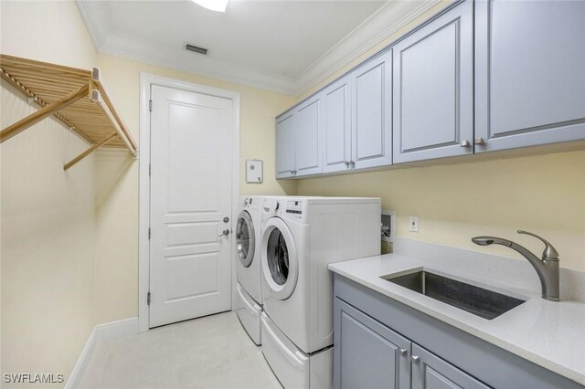 6632 Glen Arbor Way, Naples, FL 34119 - laundry area featuring cabinet space, washing machine and dryer, ornamental molding, and light tile patterned flooring
