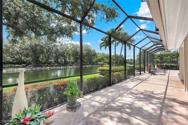 6632 Glen Arbor Way, Naples, FL 34119 - view of patio / terrace with a water view, a lanai, and view of scattered trees