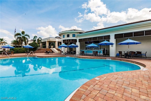 6632 Glen Arbor Way, Naples, FL 34119 - community pool with a patio and outdoor dining area