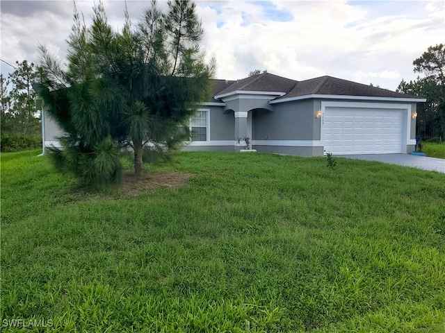 3009 44th St W, Lehigh Acres, FL 33971 - view of front of property with stucco siding, driveway, a garage, and a front lawn