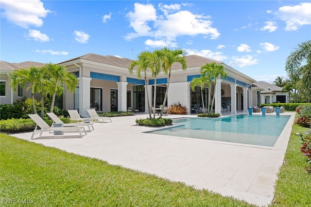 4297 Deephaven Ln, Naples, FL 34119 - back of property with a patio area, an outdoor pool, a yard, and stucco siding