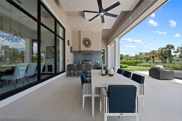 4297 Deephaven Ln, Naples, FL 34119 - view of patio with exterior kitchen, ceiling fan, outdoor dining area, and an outdoor hangout area
