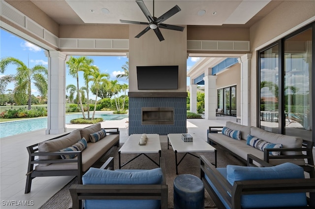 4297 Deephaven Ln, Naples, FL 34119 - view of patio / terrace with an outdoor living space with a fireplace, a ceiling fan, and an outdoor pool