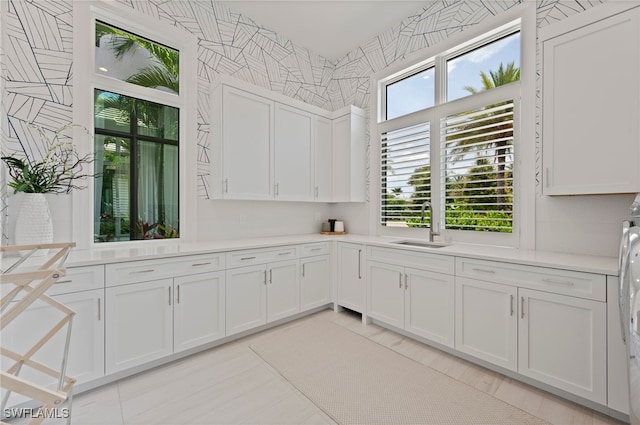 4297 Deephaven Ln, Naples, FL 34119 - kitchen featuring white cabinetry, light countertops, and light tile patterned floors
