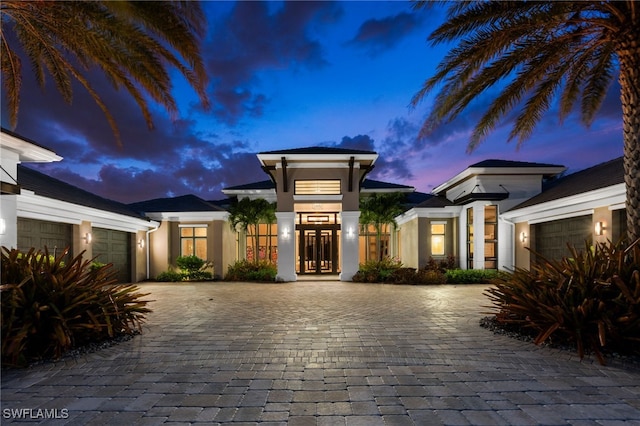 4297 Deephaven Ln, Naples, FL 34119 - view of front of house featuring decorative driveway, a garage, and stucco siding