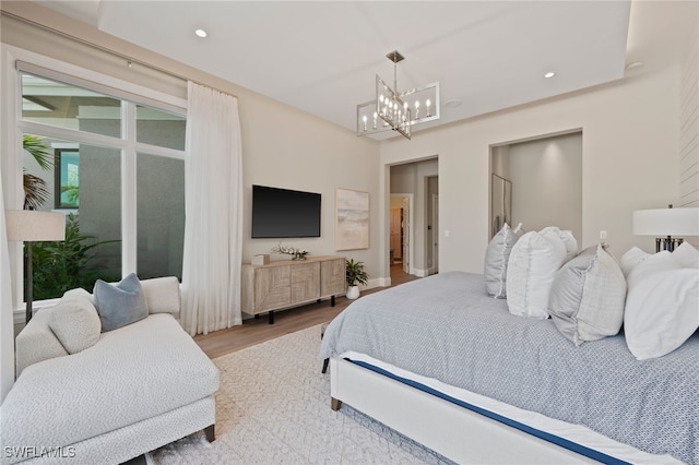4297 Deephaven Ln, Naples, FL 34119 - bedroom with a chandelier, wood finished floors, and recessed lighting