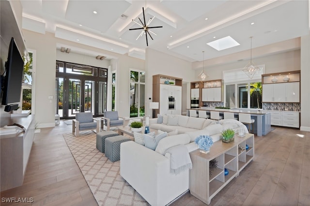4297 Deephaven Ln, Naples, FL 34119 - living room with light wood finished floors, a skylight, a high ceiling, recessed lighting, and coffered ceiling