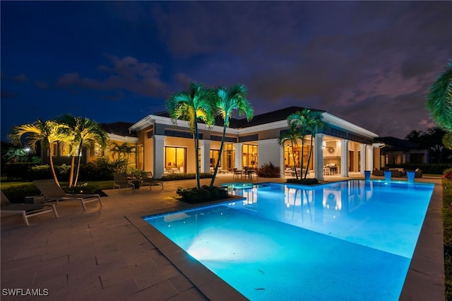 4297 Deephaven Ln, Naples, FL 34119 - pool at night with an outdoor pool and a patio