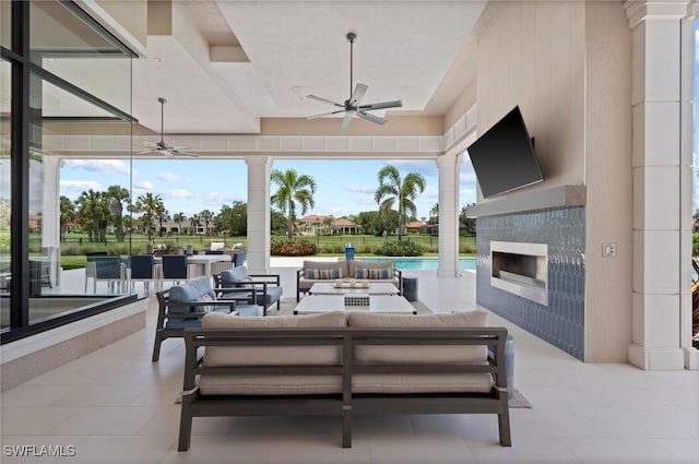 4297 Deephaven Ln, Naples, FL 34119 - view of patio with ceiling fan and an outdoor living space with a fireplace