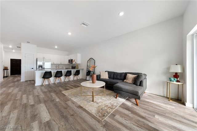 2429/2431 Lola Ave S, Lehigh Acres, FL 33973 - living area featuring light wood-style flooring and recessed lighting
