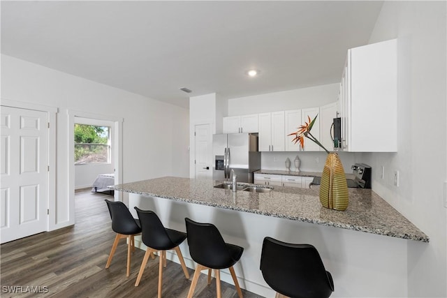 2429/2431 Lola Ave S, Lehigh Acres, FL 33973 - kitchen with range, a peninsula, stainless steel fridge with ice dispenser, light stone counters, and recessed lighting