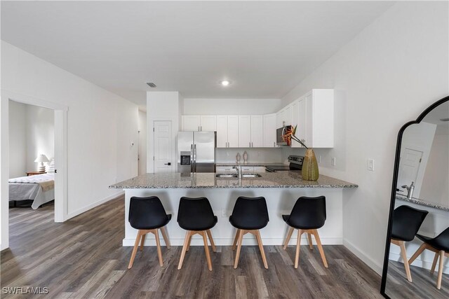2429/2431 Lola Ave S, Lehigh Acres, FL 33973 - kitchen with stainless steel fridge, black range with electric stovetop, a peninsula, dark wood-type flooring, and recessed lighting