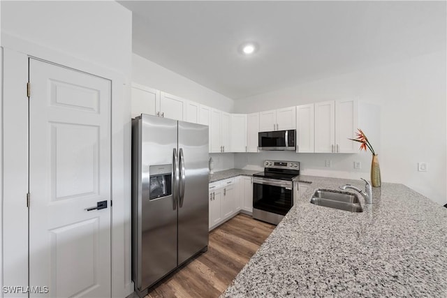 2429/2431 Lola Ave S, Lehigh Acres, FL 33973 - kitchen featuring stainless steel appliances, light stone countertops, white cabinetry, dark wood-type flooring, and recessed lighting
