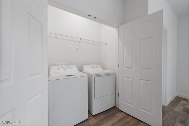 2429/2431 Lola Ave S, Lehigh Acres, FL 33973 - laundry room featuring washing machine and clothes dryer and dark wood finished floors