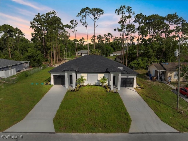 2429/2431 Lola Ave S, Lehigh Acres, FL 33973 - view of front facade with concrete driveway, a garage, and a front yard