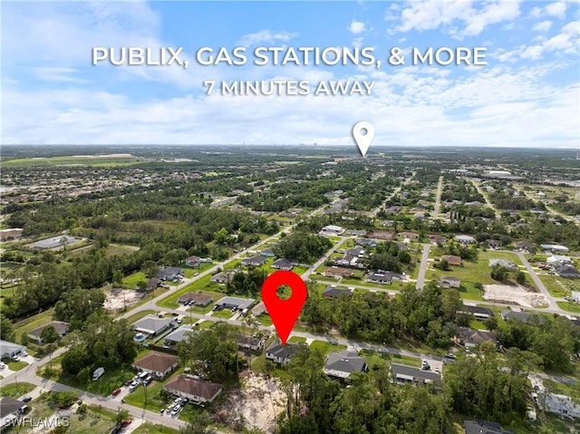 2429/2431 Lola Ave S, Lehigh Acres, FL 33973 - aerial view of property and surrounding area with nearby suburban area