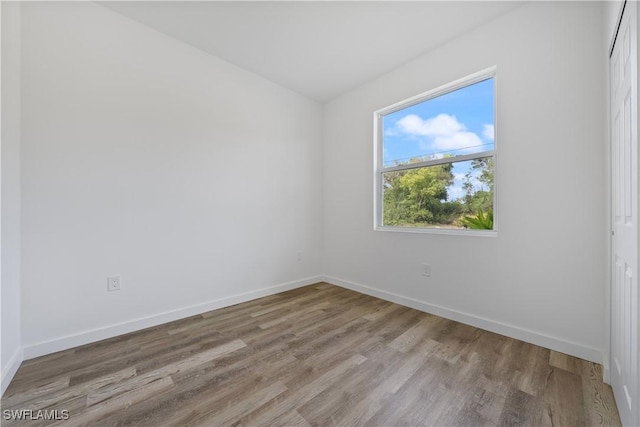 2429/2431 Lola Ave S, Lehigh Acres, FL 33973 - unfurnished room with wood finished floors and baseboards