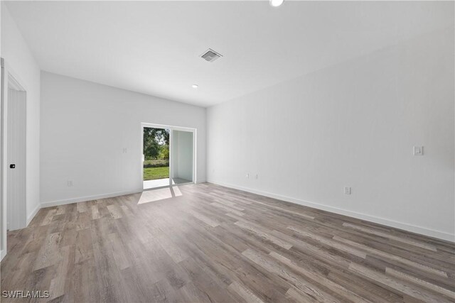 2429/2431 Lola Ave S, Lehigh Acres, FL 33973 - spare room featuring light wood finished floors and recessed lighting