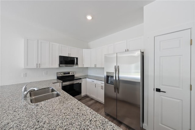 2429/2431 Lola Ave S, Lehigh Acres, FL 33973 - kitchen with stainless steel appliances, light stone counters, white cabinets, dark wood-type flooring, and recessed lighting