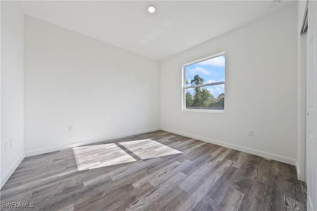 2429/2431 Lola Ave S, Lehigh Acres, FL 33973 - empty room with baseboards and wood finished floors