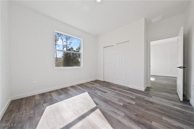 2429/2431 Lola Ave S, Lehigh Acres, FL 33973 - unfurnished bedroom featuring wood finished floors and a closet