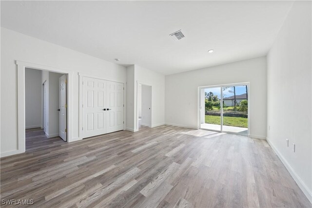 2429/2431 Lola Ave S, Lehigh Acres, FL 33973 - unfurnished bedroom featuring access to outside, wood finished floors, and a closet