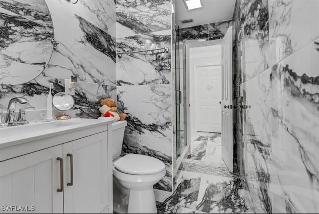 4442 18th Ave SW, Naples, FL 34116 - bathroom featuring marble tiled floors, a marble finish shower, vanity, and tile walls