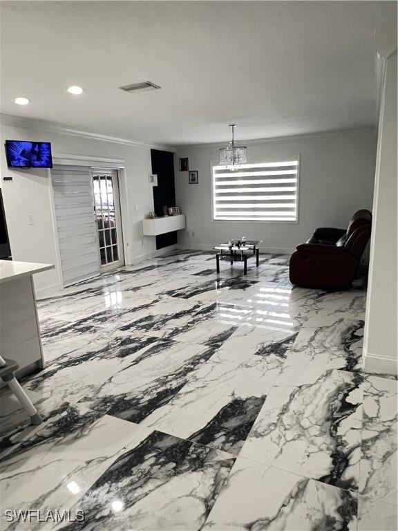 4442 18th Ave SW, Naples, FL 34116 - living room featuring ornamental molding, a chandelier, and recessed lighting