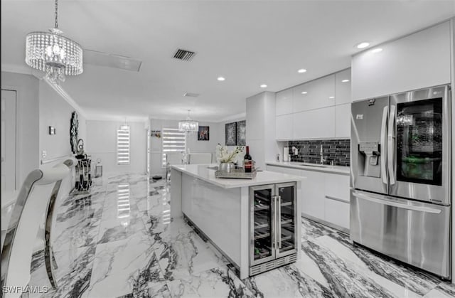 4442 18th Ave SW, Naples, FL 34116 - kitchen featuring stainless steel fridge, modern cabinets, wine cooler, white cabinets, and recessed lighting